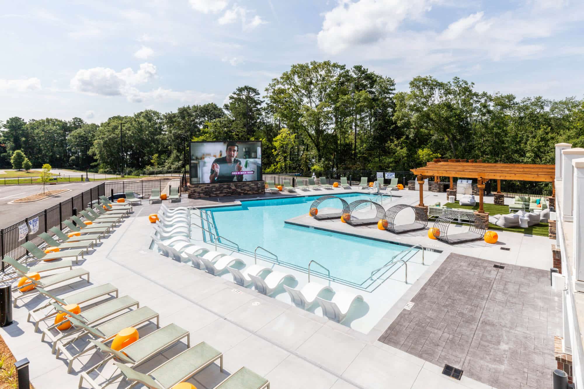 signature hartwell village off campus apartments near clemson university resort style pool with jumbotron and lounge seating
